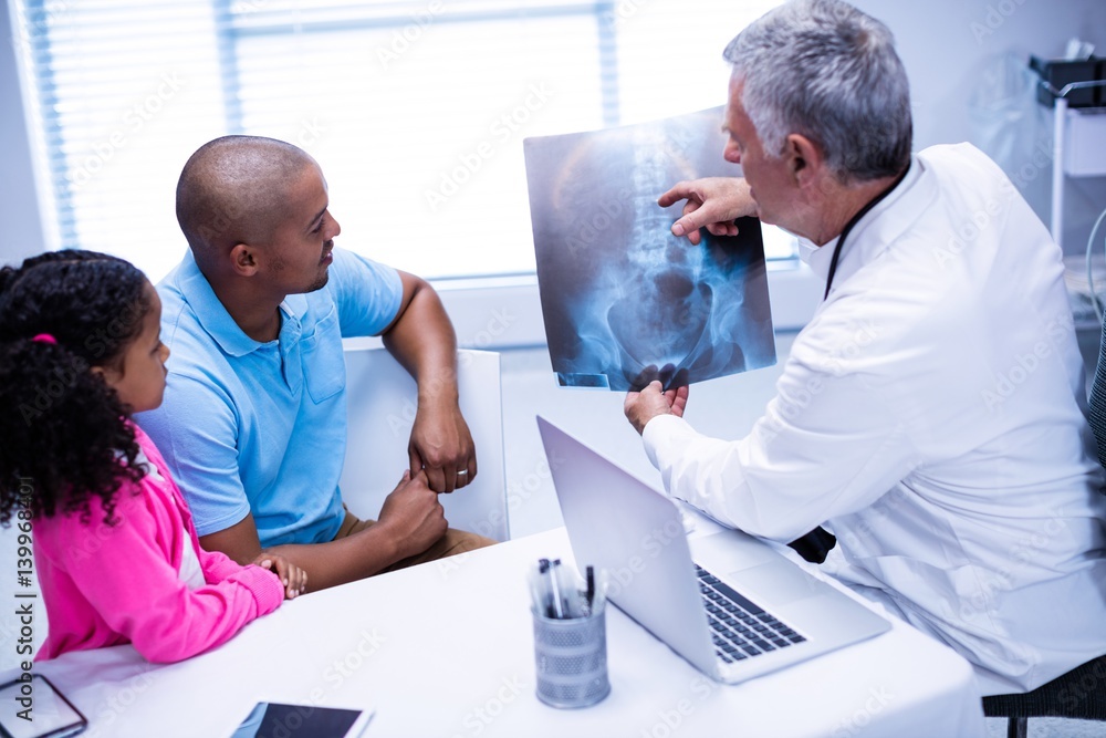 Doctor discussing x-ray report with patient Doctor discussing x-ray report with patient