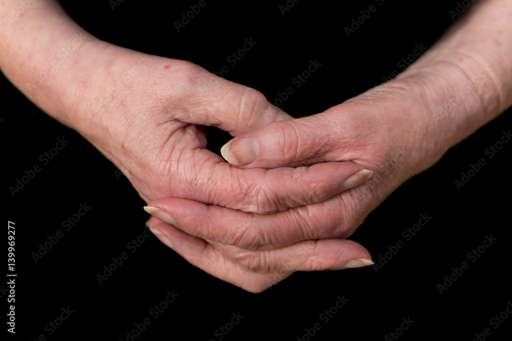 Close up of a female pensioner's hands loosely clasped