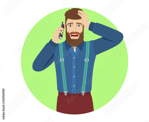 Hipster talking on the mobile phone and grabbed his head