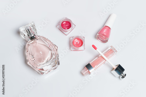 Perfume bottle, nail polish, lipstick. Fashion woman still life. Pop female things on white background.