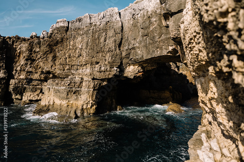cave in a rock ashore ocean