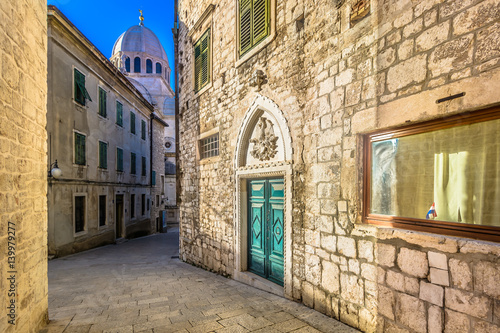 Sibenik city center Croatia.   Scenic view at narrow mediterranean streets in old city center of town Sibenik with marble cathedral in background.