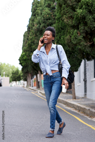 young woman talking and walking with mobile phone