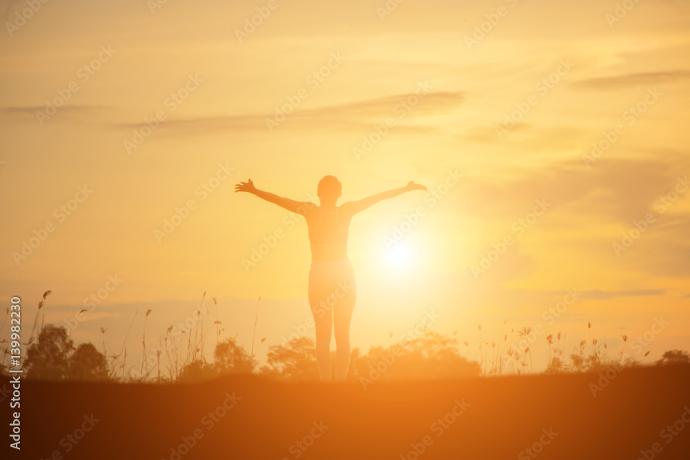 Silhouette of woman praying over beautiful sky background Silhouette of woman praying over beautiful sky background