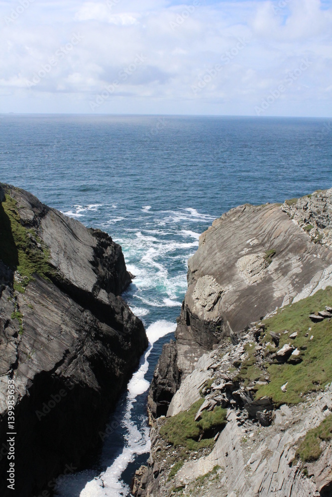 View to the ocean through rocks Ireland View to the ocean through rocks Ireland