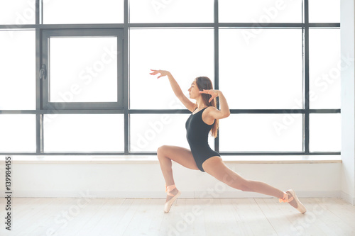 Beautiful young athletic woman dancer at a training session. Ballerina. Preparing for the competition.