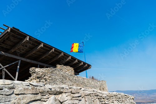 Romanian flag on the walls of the old medieval  fortress photo