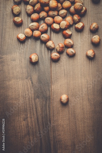 hazelnuts on the brown wooden table background