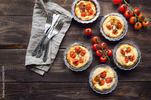 Fresh homemade tarts with cherry tomatoes and goat cheese