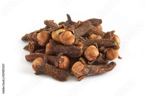 Pile of cloves isolated on white background, selective focus