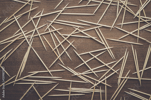 many wooden toothpicks on the brown table texture