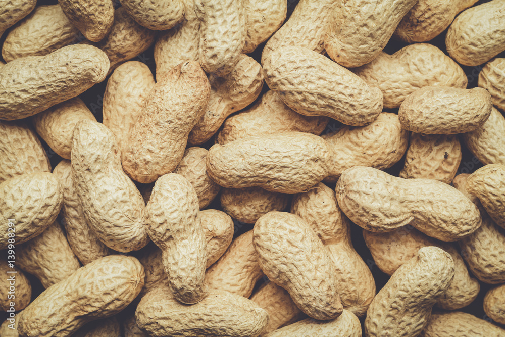 many roasted peanuts on the table background many roasted peanuts on the table background