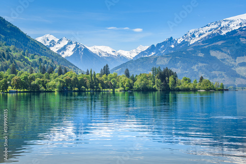 Reflection of a snowy mountain range, Zell am See, Austria