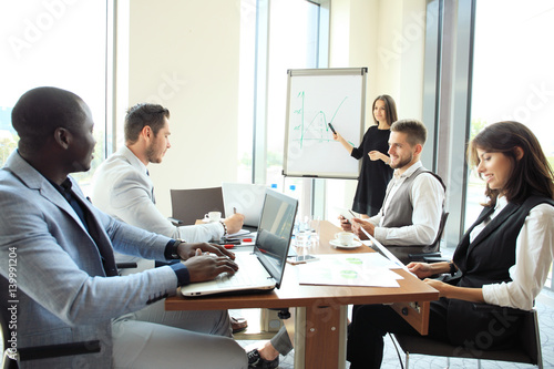 Woman making a business presentation to a group.