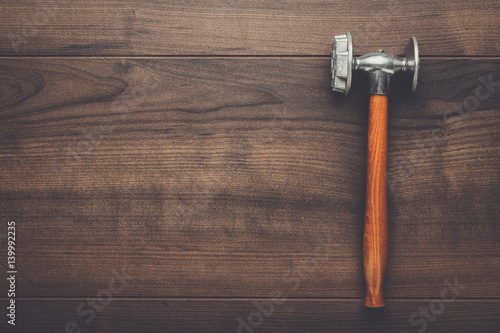 kitchen hammer on the brown wooden table