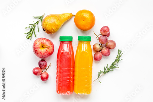 bottles of smoothie with fruits on white table top view mock up