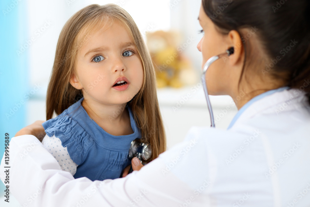Doctor examining a little girl by stethoscope Doctor examining a little girl by stethoscope