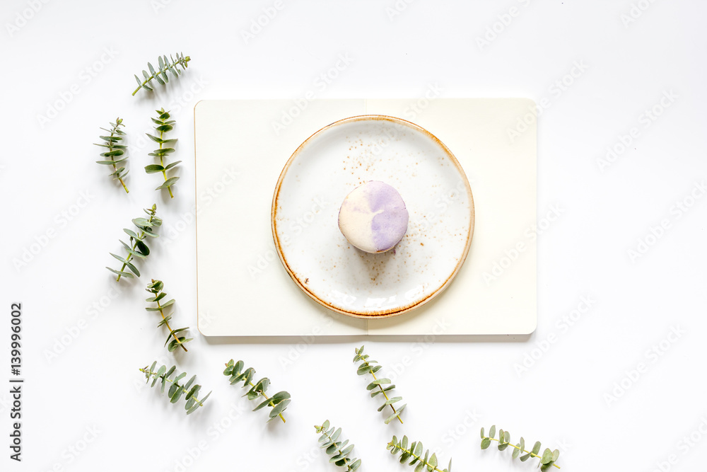 woman table with notebook, macaroons and eucalyptus top view mock-up woman table with notebook, macaroons and eucalyptus top view mock-up