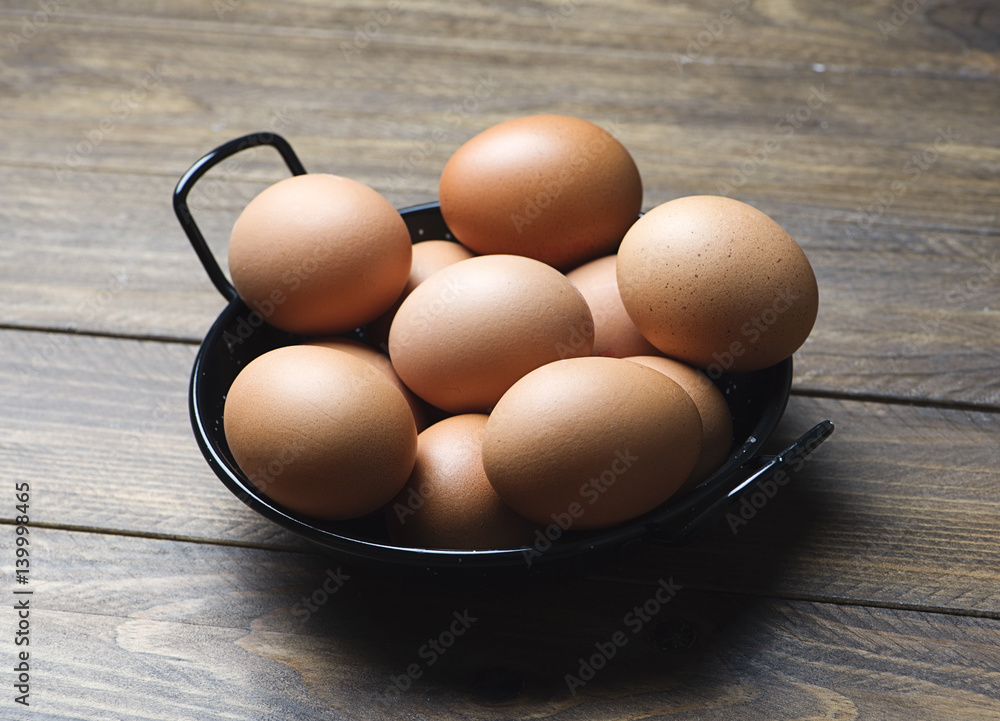 Casserole with eggs on brown wooden table. Horizontal shoot. Casserole with eggs on brown wooden table. Horizontal shoot.