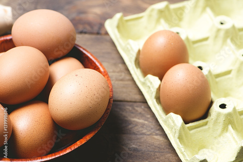 Eggs on brown wooden table. Horizontal shoot.