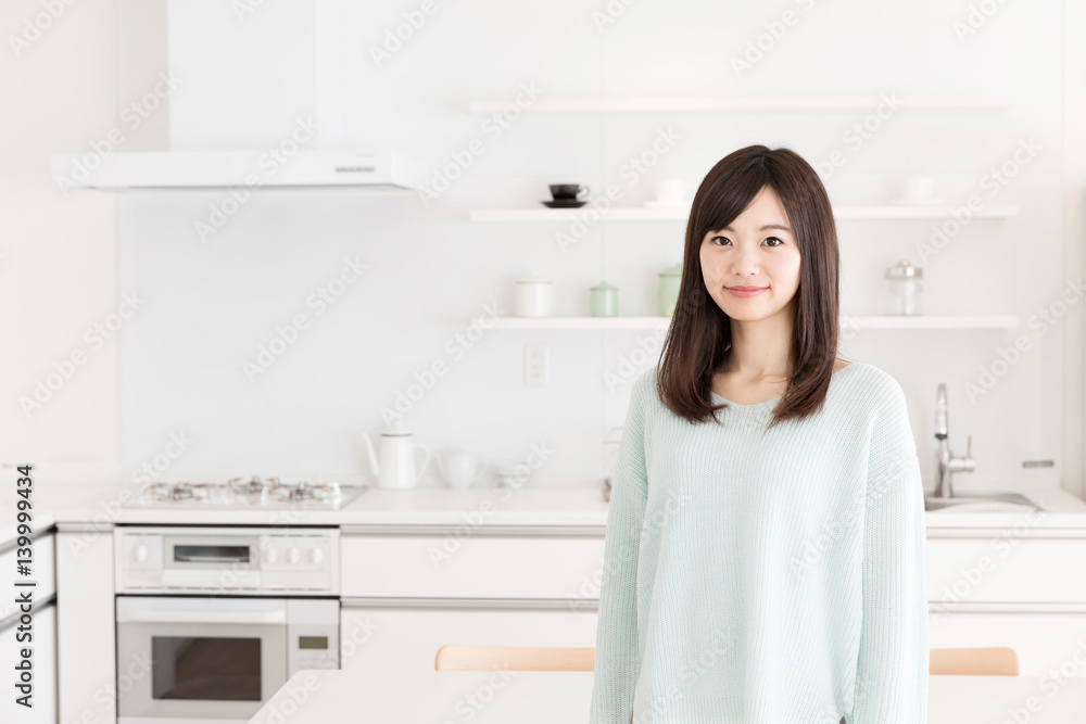 portrait of young asian woman in the kitchen portrait of young asian woman in the kitchen