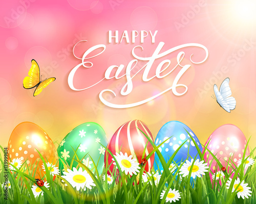 Happy Easter on pink background and eggs on grass