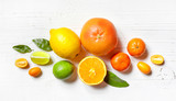 various citrus fruits on white wooden table