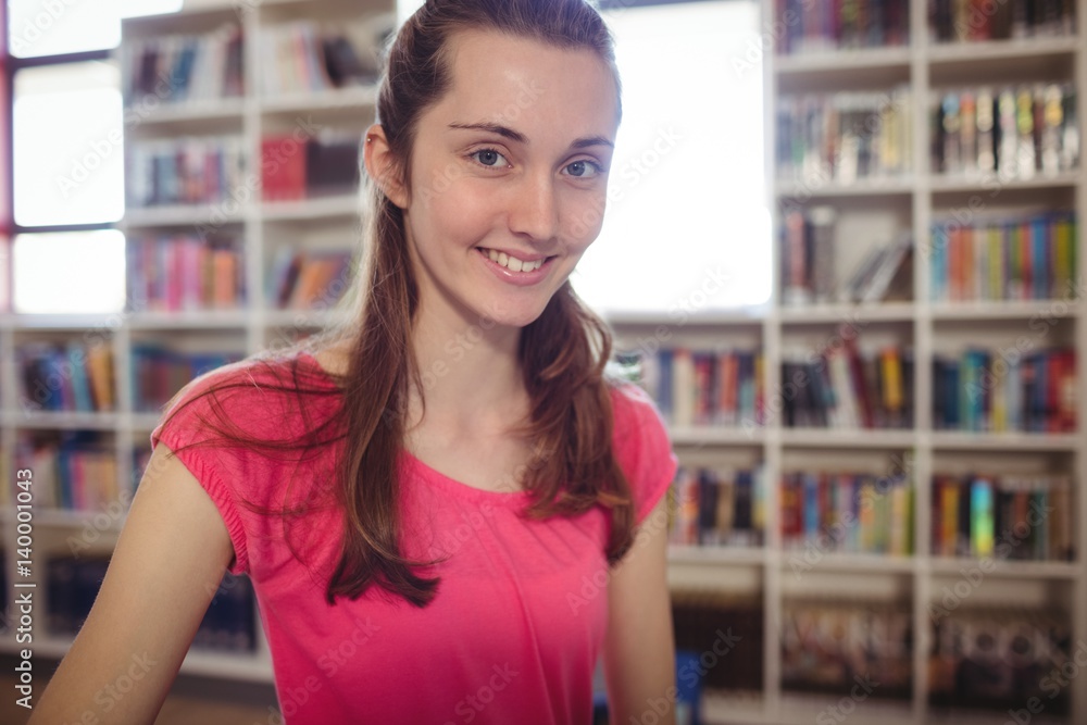 Portrait of smiling schoolgirl in library Portrait of smiling schoolgirl in library