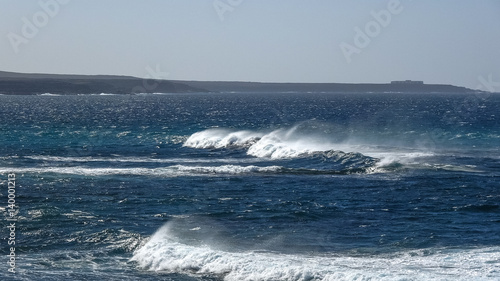 Ocean waves on the black rocky coastline in Canarias © yashka7