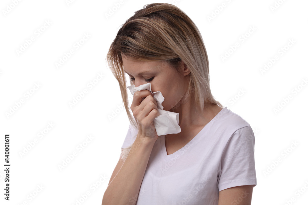 Woman sneezing and holding tissue isolated on white background. Flu symptoms, allergy . Healthcare and medical concept Woman sneezing and holding tissue isolated on white background. Flu symptoms, allergy . Healthcare and medical concept