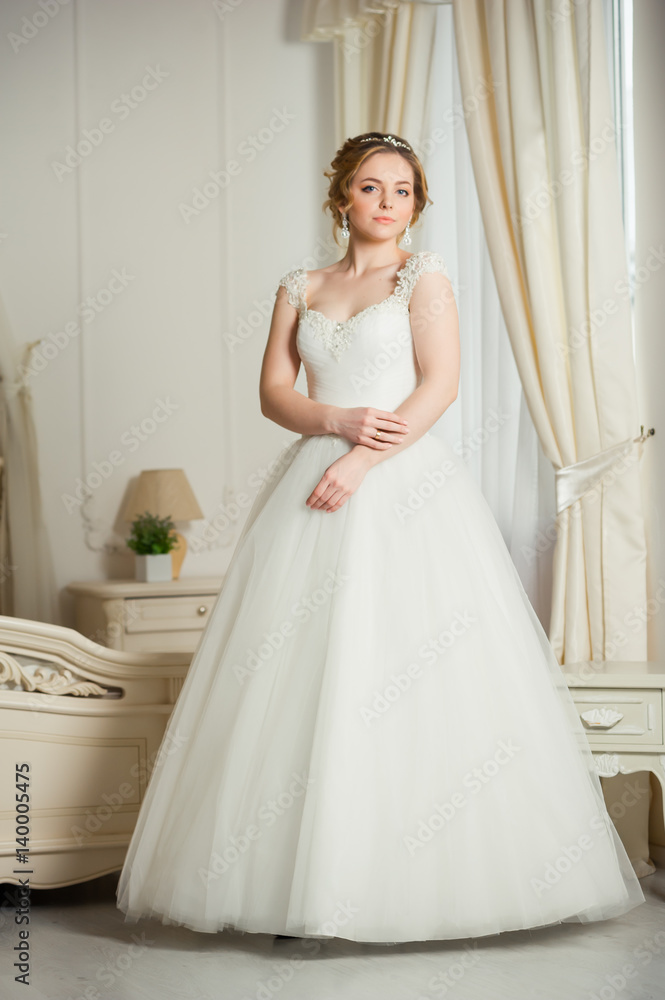 Beautiful bride before wedding ceremony in appartament