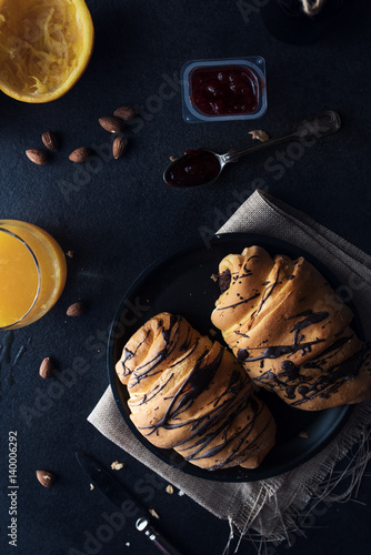 Fresh croissant with chocolate glaze on breakfast