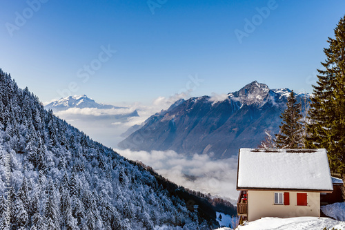 Natural landscape with lonely house in the snow. Alps. photo
