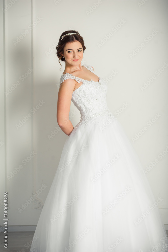 Smiling bride holding big wedding bouquet