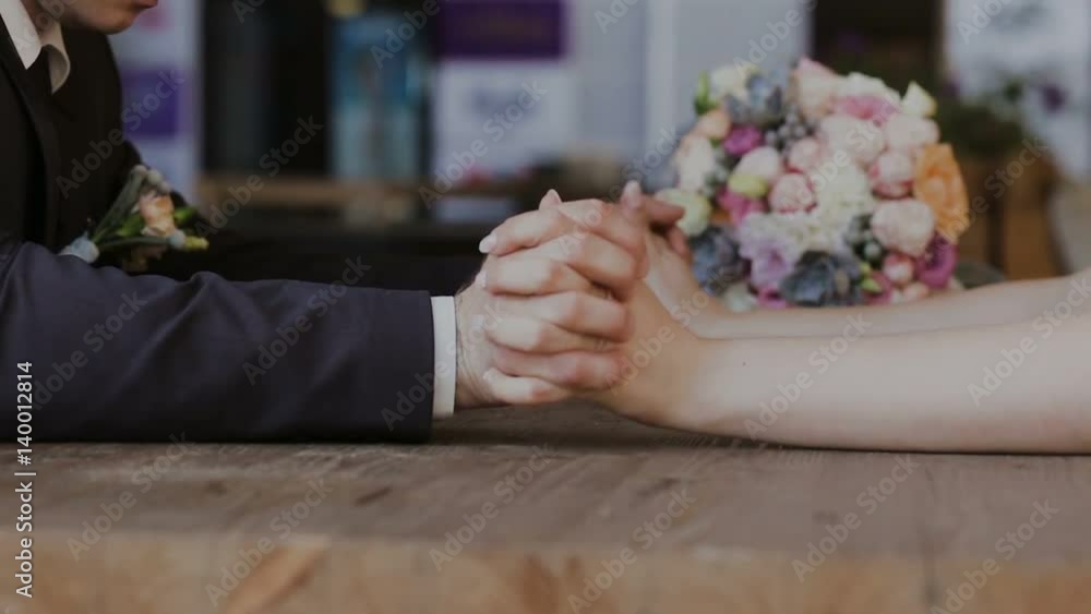 Detail of two lovers joining hands Detail of two lovers joining hands