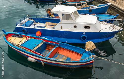 Small fishing boats in harbor of Syracuse on Sicily island, Italy