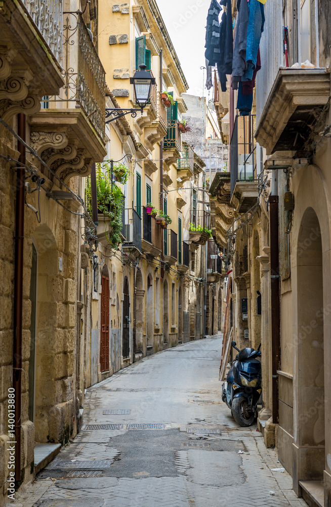 Alley on the Ortygia isle - old town of Syracuse on Sicily island, Italy