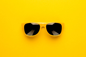 studio shot of yellow sunglasses. summer is coming concept