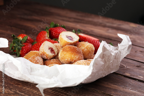 Bomboloni - traditional Italian doughnuts stuffed with strawberry jam photo