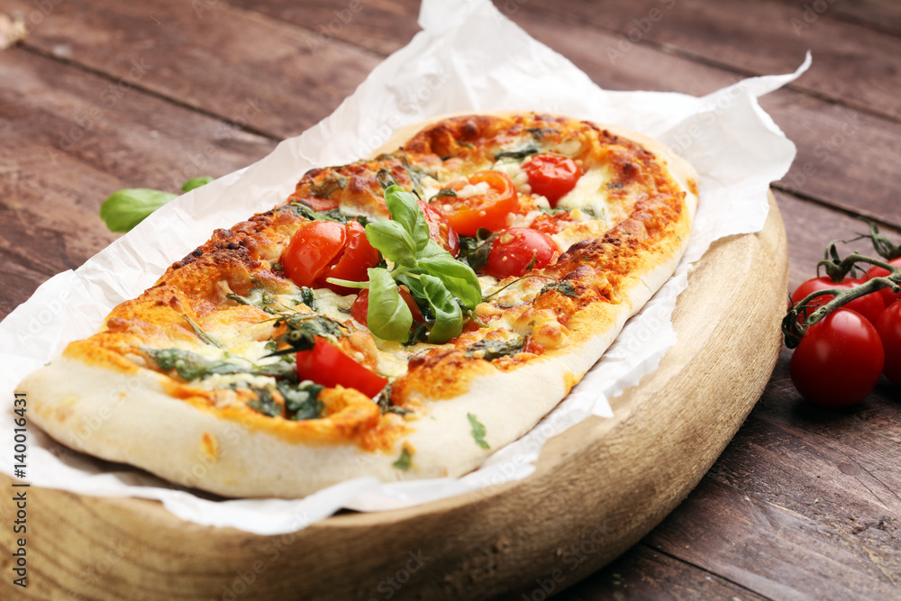 Hot pizza slice with melting cheese on a rustic wooden table. Hot pizza slice with melting cheese on a rustic wooden table.