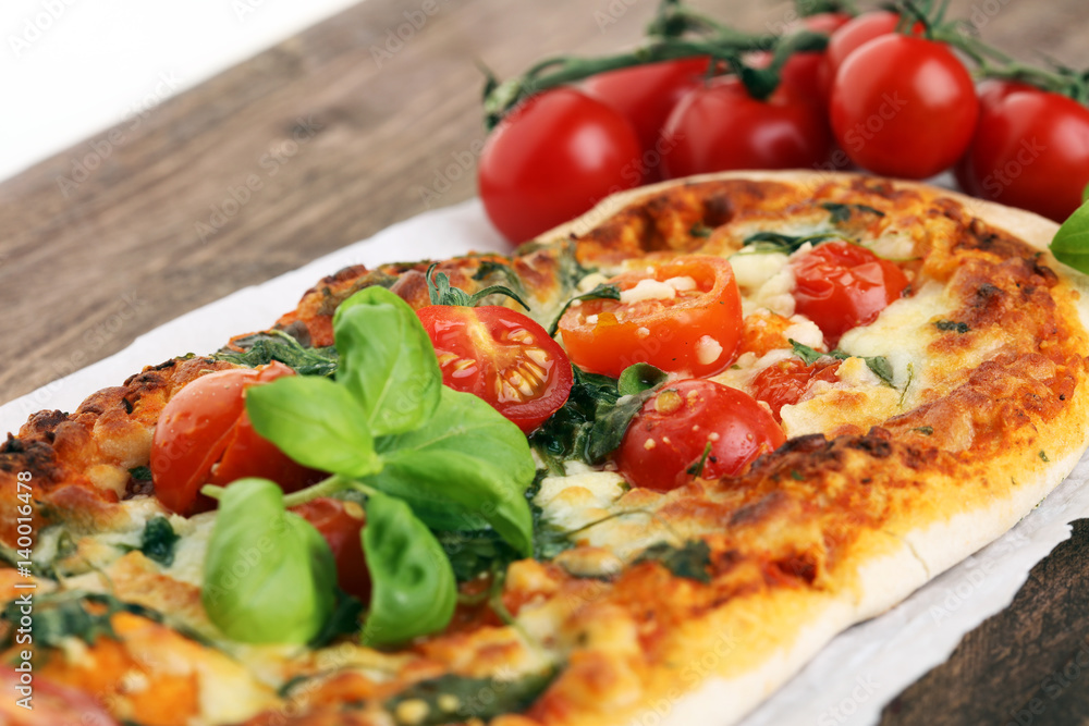 Hot pizza slice with melting cheese on a rustic wooden table. Hot pizza slice with melting cheese on a rustic wooden table.