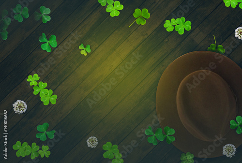 Spring Saint Patrick's Day, dark wood background with green clovers photo