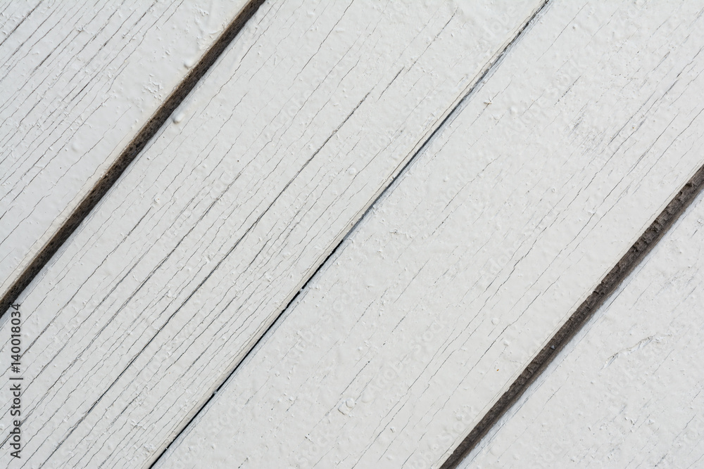 Wooden boards have a diagonal arrangement, painted with gray paint, visible wood texture and small cracks, abstract background Wooden boards have a diagonal arrangement, painted with gray paint, visible wood texture and small cracks, abstract background