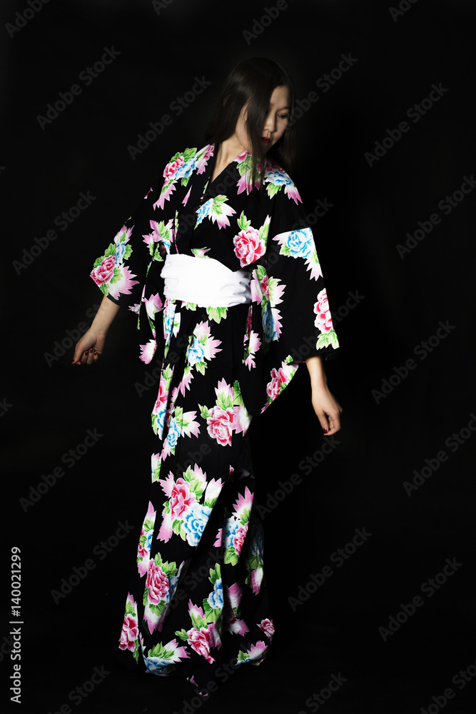 Japanese girl in traditional Japanese kimono on black background. Japanese girl in traditional Japanese kimono on black background.