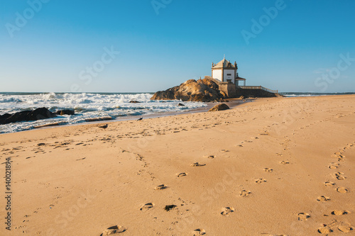 Konstfotografi Ocean surf and Chapel Senhor da Pedra at Miramar Beach, near Porto, Portugal