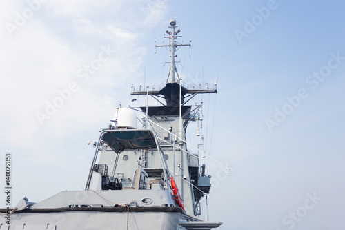 Grey modern warship sailing in still water © AU USAnakul+