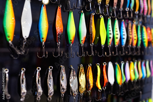 Different colorful fishing baits on black
