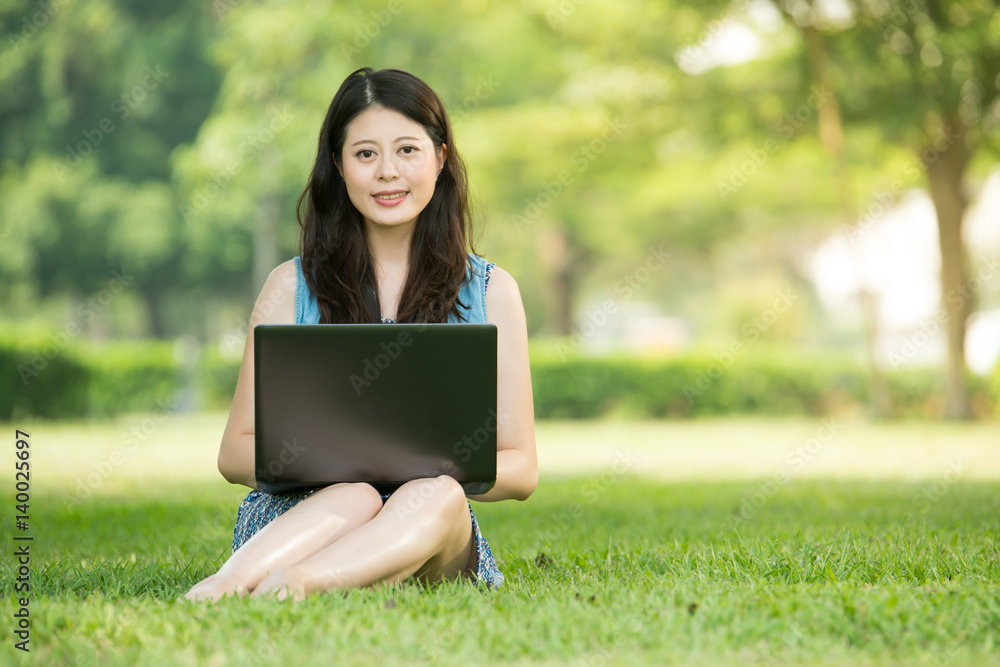 beautiful asian woman using computer in outdoor park beautiful asian woman using computer in outdoor park
