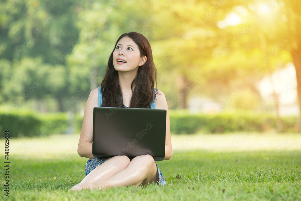 beautiful asian woman using computer in outdoor park beautiful asian woman using computer in outdoor park