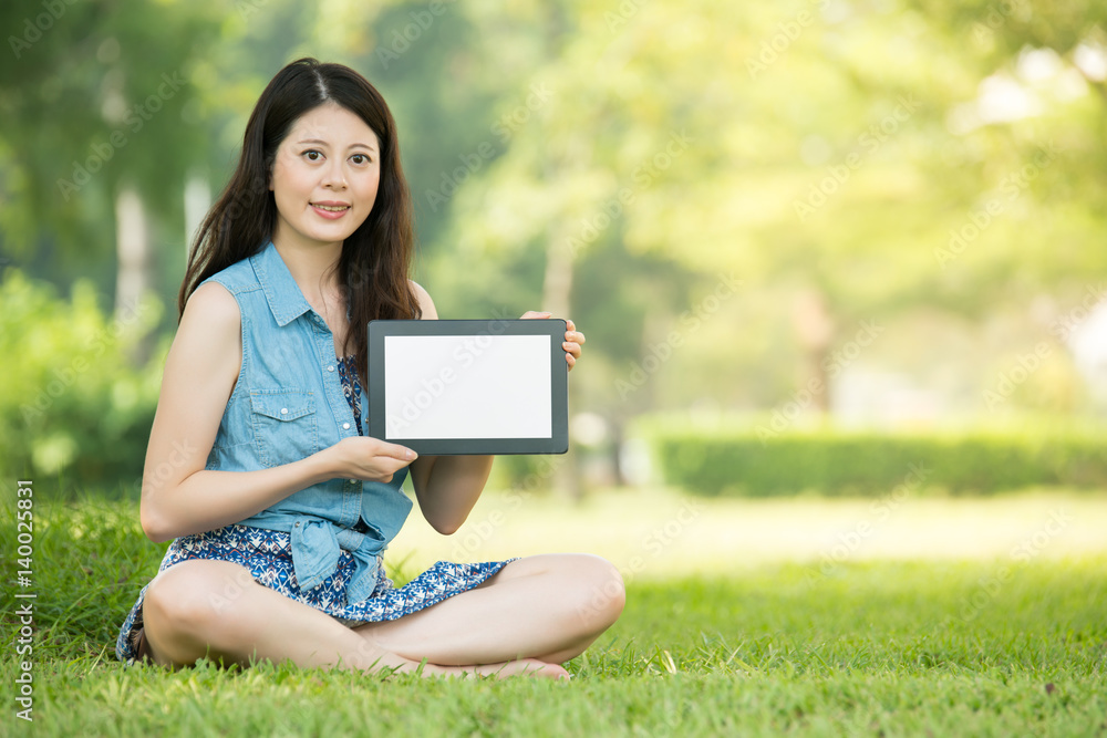 beauty asian woman presenting digital tablet in outdoor